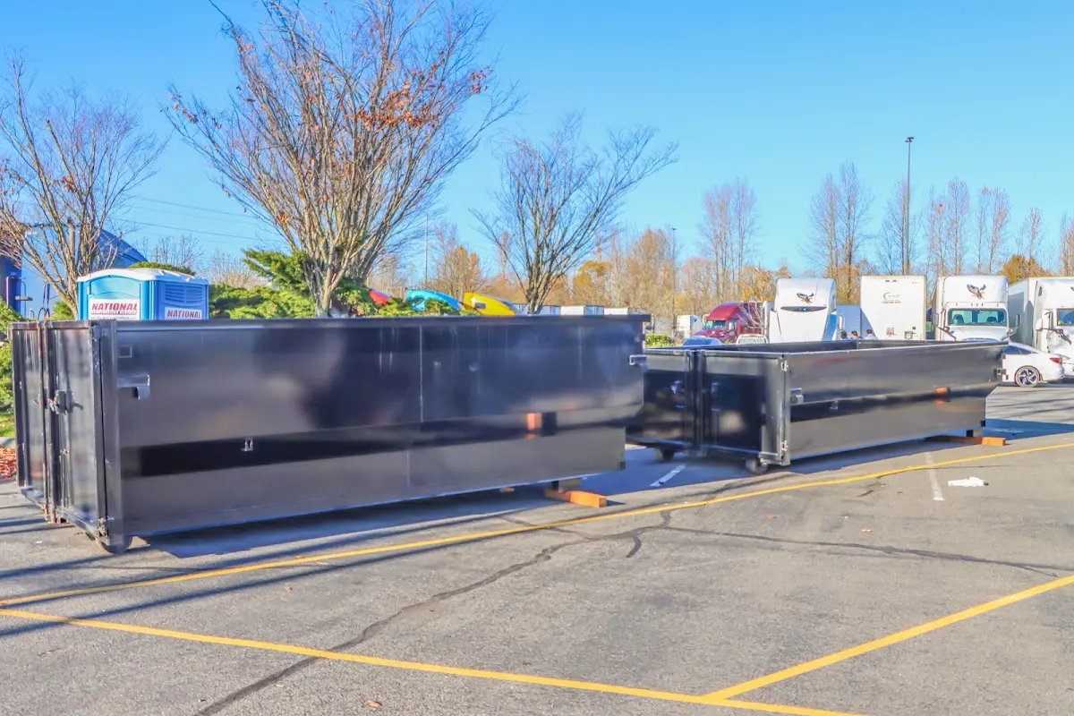 Professional dumpster rental service with roll-off container on residential driveway in Stoughton